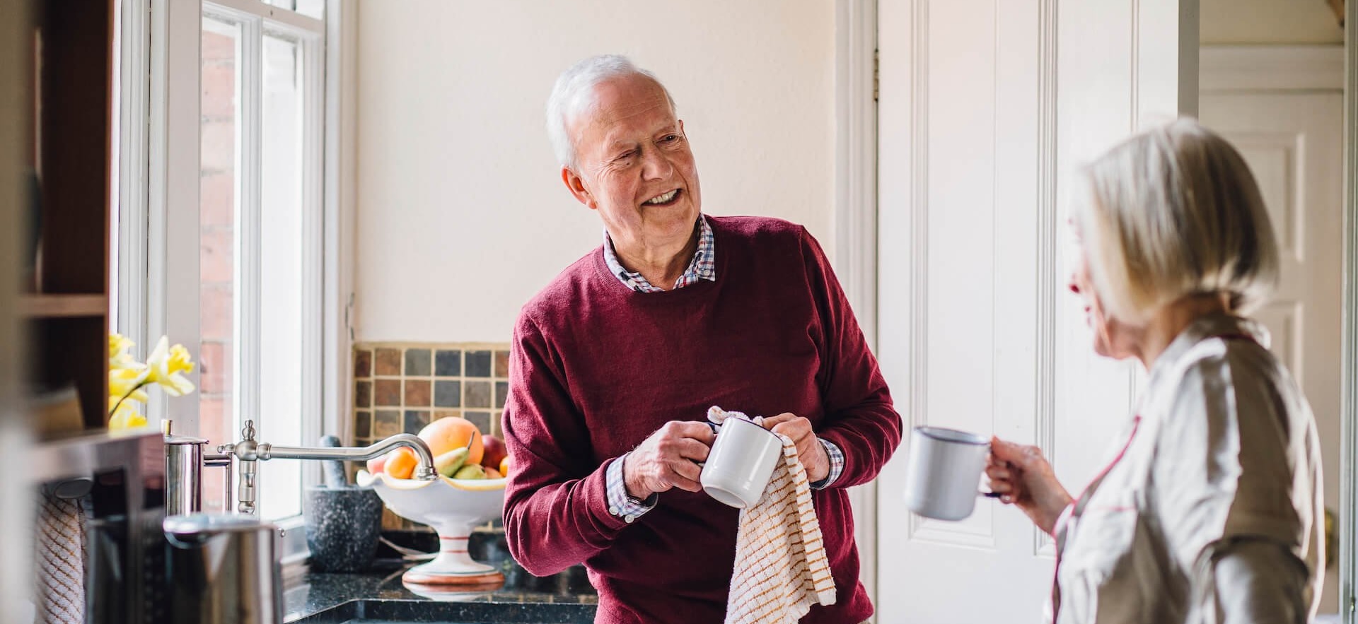 older gentleman chatting to home care provider